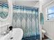 Updated bathroom with a pedestal sink, shower/tub combo, and a stylish shower curtain at 104 Sunset Way, Fruitland Park, FL 34731