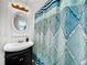 Small bathroom featuring a pedestal sink, shower/tub combo, and a patterned shower curtain at 104 Sunset Way, Fruitland Park, FL 34731