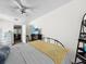 Bright bedroom with a comfortable bed, TV, and decorative fireplace at 104 Sunset Way, Fruitland Park, FL 34731