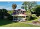 Quaint yellow house with red roof and a front porch at 104 Sunset Way, Fruitland Park, FL 34731