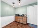 Simple kitchen with wooden floors, white cabinets, and dark countertops at 104 Sunset Way, Fruitland Park, FL 34731