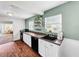 Efficient galley kitchen features white cabinets, black countertops, and modern appliances at 104 Sunset Way, Fruitland Park, FL 34731