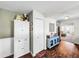 White kitchen features a pantry and open concept to the living room at 104 Sunset Way, Fruitland Park, FL 34731