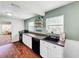 White kitchen cabinets and dark countertops, open to the living room at 104 Sunset Way, Fruitland Park, FL 34731