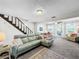 Spacious living room with light gray sectional sofa, fireplace, and access to backyard at 104 Sunset Way, Fruitland Park, FL 34731