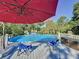 Lovely above ground pool with red umbrella and deck at 104 Sunset Way, Fruitland Park, FL 34731