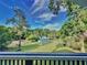 Relaxing pool area with deck and view of lush trees at 104 Sunset Way, Fruitland Park, FL 34731