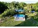 Aerial view of a home's backyard oasis, featuring a relaxing pool with a spacious deck at 104 Sunset Way, Fruitland Park, FL 34731