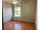 Bright bedroom featuring wood floors and an arched window at 12512 Belrose Ave, Orlando, FL 32837