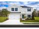 Two-story house with white siding, gray accents, and a two-car garage at 1653 Laia Rd, Haines City, FL 33844