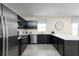 Modern kitchen with dark cabinetry, stainless steel appliances, and white countertops at 1653 Laia Rd, Haines City, FL 33844