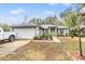 One-story house with a gray roof, attached garage, and landscaped yard at 42 Dogwood Drive Crse, Ocala, FL 34472