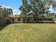 Spacious backyard showcasing home's exterior at 1910 E Pollock Rd, Lakeland, FL 33813