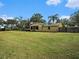 Large backyard with home and screened porch at 1910 E Pollock Rd, Lakeland, FL 33813