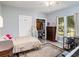 Bright bedroom with double bed, dresser, and ample closet space at 1910 E Pollock Rd, Lakeland, FL 33813