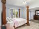 Main bedroom with a large four-poster bed and plenty of natural light at 1910 E Pollock Rd, Lakeland, FL 33813