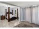 Bedroom with four-poster bed and access to additional space at 1910 E Pollock Rd, Lakeland, FL 33813