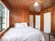 Bedroom with wood paneled walls and a large bed at 1910 E Pollock Rd, Lakeland, FL 33813