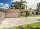 Stone house with attached garage and a long driveway at 1910 E Pollock Rd, Lakeland, FL 33813