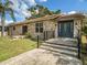 Stone house with a dark blue front door and a walkway at 1910 E Pollock Rd, Lakeland, FL 33813