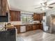 Rustic kitchen with wooden cabinets, stainless steel appliances, and light flooring at 1910 E Pollock Rd, Lakeland, FL 33813