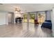 Living room with sliding doors to backyard, a home office space, and hardwood floors at 1910 E Pollock Rd, Lakeland, FL 33813
