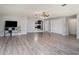 Open living room with hardwood floors and a view into the kitchen at 1910 E Pollock Rd, Lakeland, FL 33813