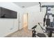 Home gym with weight machine and large TV at 2312 Crossbow St, Clermont, FL 34715