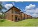 Exterior view of townhouses, well maintained lawn at 216 Calabria Ave, Davenport, FL 33897