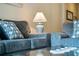 Close-up view of living room with blue sofas and pillows at 216 Calabria Ave, Davenport, FL 33897
