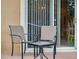 Relaxing patio with two chairs and a small table at 216 Calabria Ave, Davenport, FL 33897