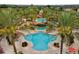 Community pool with palm trees and lounge chairs at 216 Calabria Ave, Davenport, FL 33897