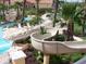 Community pool area with water slide and lounge chairs at 216 Calabria Ave, Davenport, FL 33897