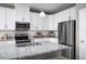 Modern kitchen with white cabinets and stainless steel appliances at 353 Crestwind Dr, Daytona Beach, FL 32124