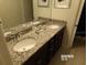 Modern double vanity with granite countertops at 5537 Misty Oak Cir, Davenport, FL 33837