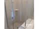 Walk-in shower with glass door and tiled walls at 5537 Misty Oak Cir, Davenport, FL 33837