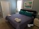 Bedroom featuring a king-size bed and teal accent pillows at 5537 Misty Oak Cir, Davenport, FL 33837