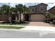 Two-story home with a paved driveway, attached garage, and landscaped front yard at 5537 Misty Oak Cir, Davenport, FL 33837