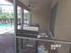 Covered patio with a grill, outdoor dining area, and view of the pool at 5537 Misty Oak Cir, Davenport, FL 33837