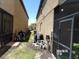 Side yard of the home with pool equipment and a screened enclosure at 5537 Misty Oak Cir, Davenport, FL 33837