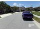 View of the street with parked cars and similar style homes at 5537 Misty Oak Cir, Davenport, FL 33837