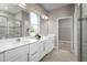 Double vanity bathroom with a large mirror and a walk-in shower at 10865 Sw 73Rd Ct, Ocala, FL 34476