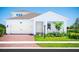 Two-story house with white siding, brick driveway, and landscaping at 10865 Sw 73Rd Ct, Ocala, FL 34476