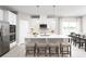 Modern kitchen with white cabinets, stainless steel appliances, and an island at 10865 Sw 73Rd Ct, Ocala, FL 34476