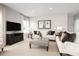 Spacious living room with comfortable sofas, a large TV, and tasteful decor at 10865 Sw 73Rd Ct, Ocala, FL 34476