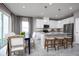 Bright dining area with a dark wood table and white chairs, adjacent to kitchen at 10918 Sw 73Rd Ct, Ocala, FL 34476