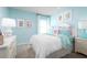 Bright bedroom with a queen bed, light blue walls, and coastal-themed decor at 10937 Sw 73Rd Ct, Ocala, FL 34476