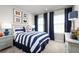 Guest bedroom with a nautical theme, striped bedding, and navy curtains at 10937 Sw 73Rd Ct, Ocala, FL 34476