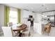 Eat-in kitchen with white cabinets, granite counters, and a wooden table at 10937 Sw 73Rd Ct, Ocala, FL 34476