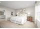Spacious bedroom with a king-size bed, neutral decor, and natural light at 10937 Sw 73Rd Ct, Ocala, FL 34476